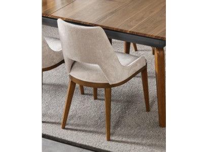 A laconic, modern chair with high wooden legs and upholstery in a pleasant, light cream color for the dining room.